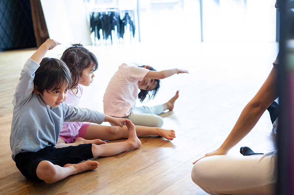 Children doing yoga in a studio